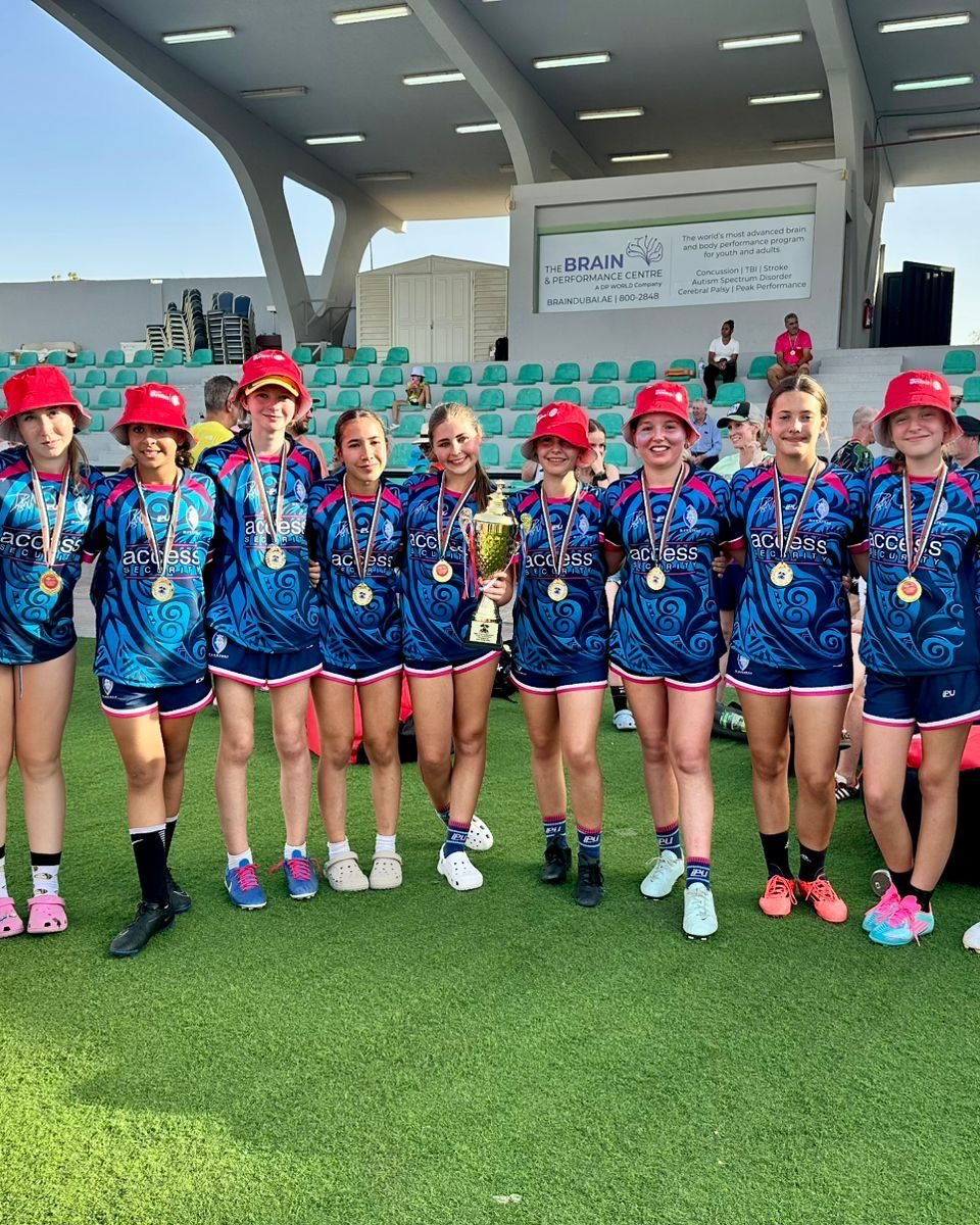 Dubai Warriors netball squad celebrate with medals and a trophy