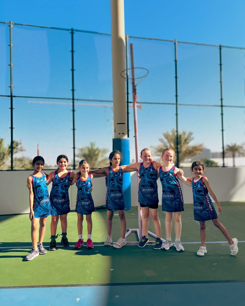 Dubai Warriors netball team stand together on court
